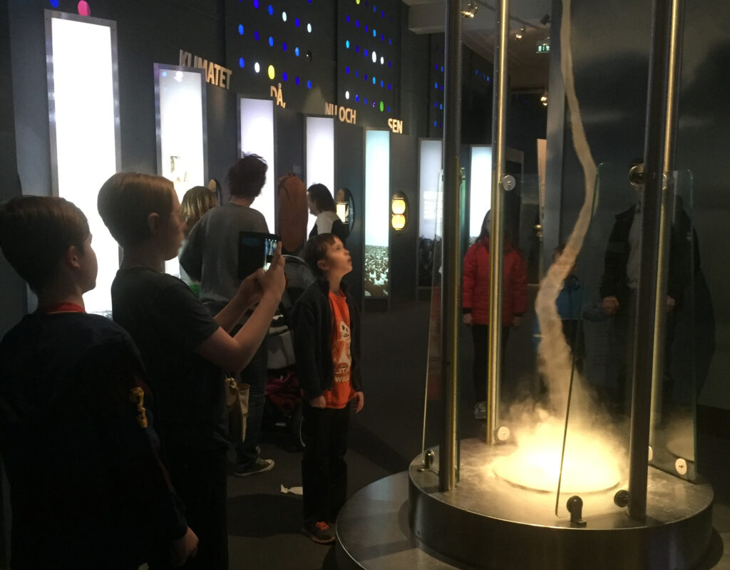image shows kids watching climate exhibit at the Natural History Museum in Stockholm