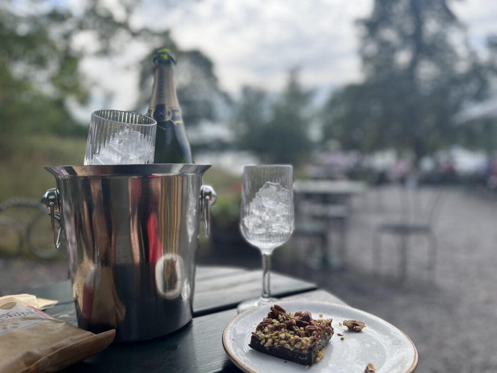 image shows bottle of champagne at outdoor cafe ektorpet in Stockholm