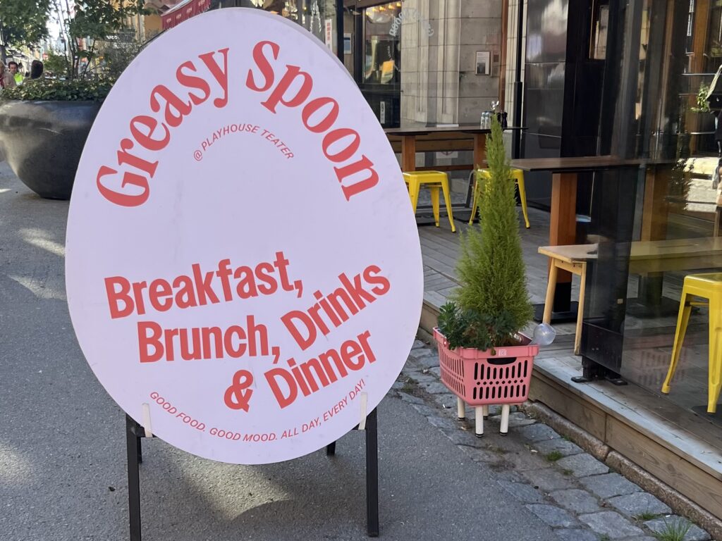 images shows sign for Greasy Spoon restaurant where families like to eat.