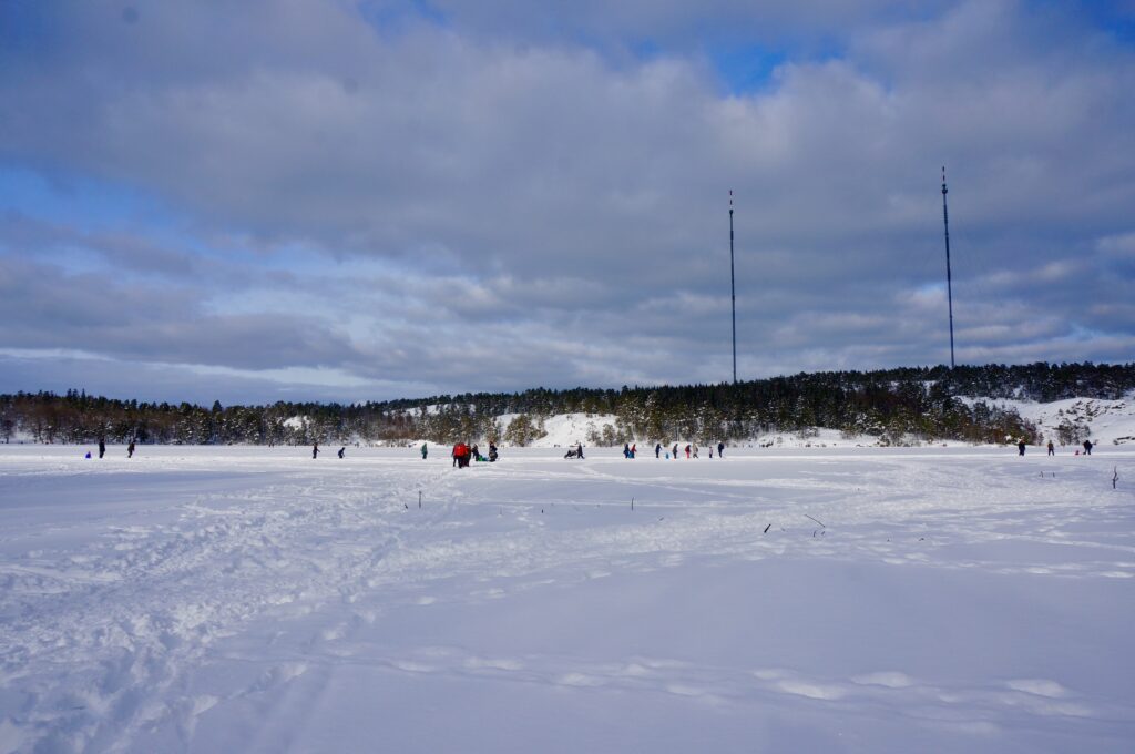 image shows people skating outdoors at Hellasgården near Stockholm